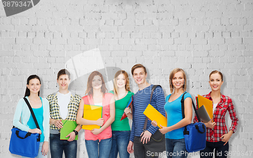 Image of group of teenage students with folders and bags