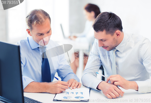 Image of businessmen with notebook on meeting