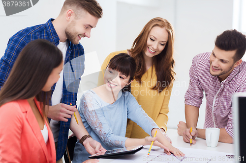 Image of happy creative team or students working at office