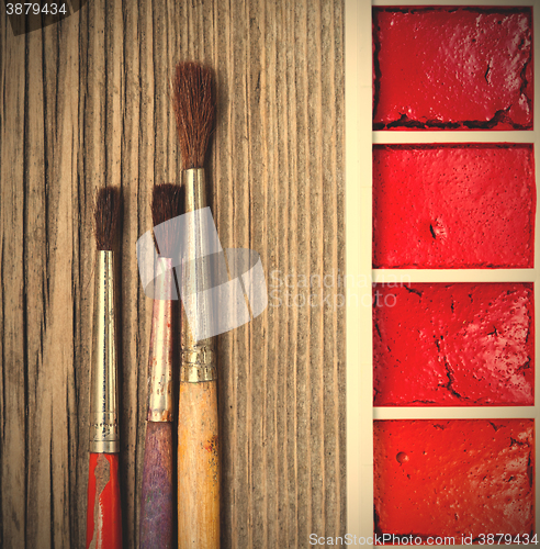 Image of Three brushes for painting and a paint-box
