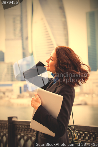 Image of smiling woman with a laptop