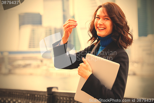 Image of laughing woman with a laptop