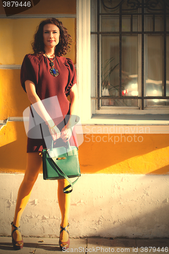 Image of beautiful woman in a burgundy dress