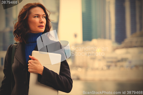 Image of Successful businesswoman with laptop