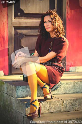 Image of middle-aged woman in a burgundy dress