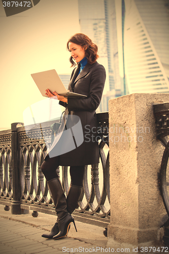 Image of businesswoman working at laptop