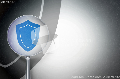 Image of Privacy concept:  Shield with optical glass on digital background