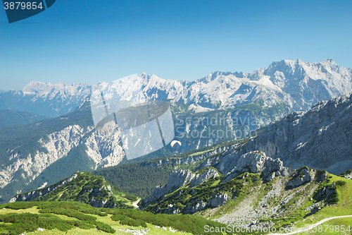 Image of Alps mountains aerial view with paraglider over Alpine landscape