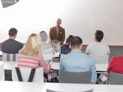 Image of teacher with a group of students in classroom