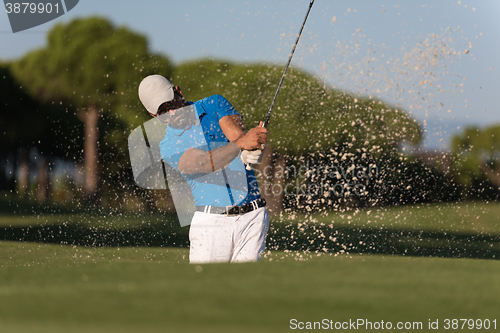 Image of pro golfer hitting a sand bunker shot