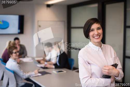 Image of hispanic businesswoman with tablet at meeting room