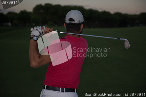 Image of golfer hitting a sand bunker shot on sunset