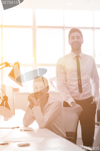 Image of business couple working together on project, sunrise in backgrou