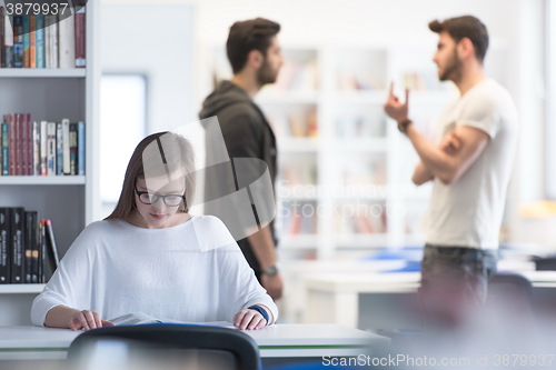 Image of female student study in school library, group of students in bac
