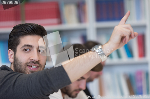 Image of group of students  raise hands up