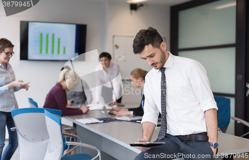 Image of young business man with tablet at office meeting room
