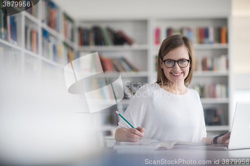 Image of female student study in school library