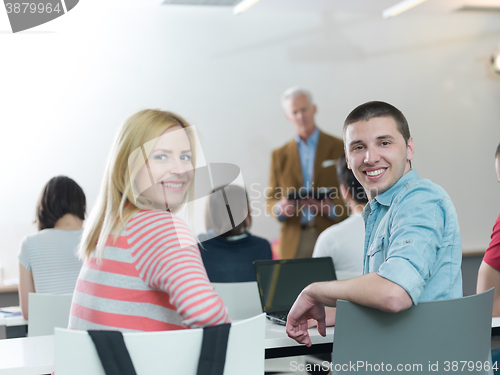 Image of teacher with a group of students in classroom