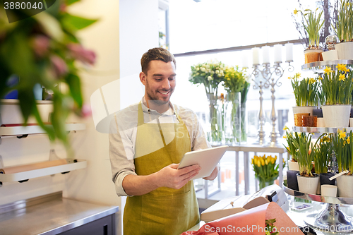 Image of man with tablet pc computer at flower shop