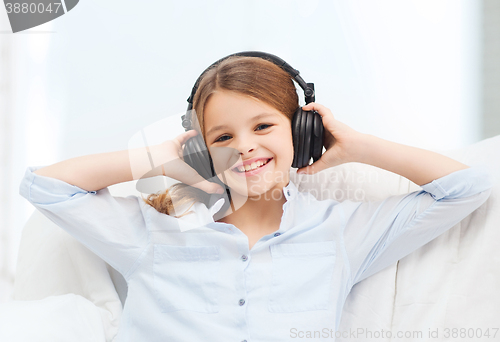 Image of smiling girl with headphones listening to music
