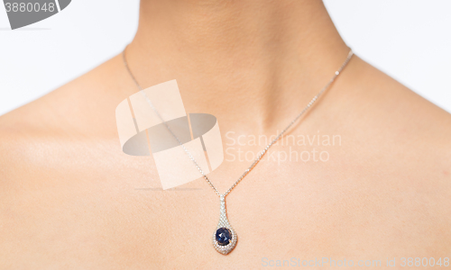 Image of close up of beautiful woman neck with pendant