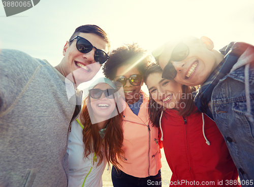 Image of smiling friends taking selfie