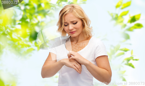 Image of unhappy woman suffering from hand inch