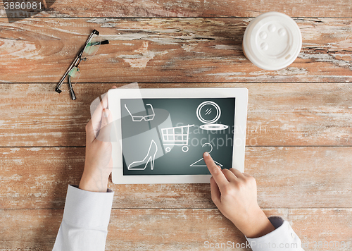 Image of close up of female hands with tablet pc and coffee