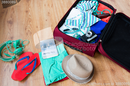 Image of close up of travel bag with clothes and stuff