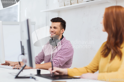 Image of creative team with headphones and computer