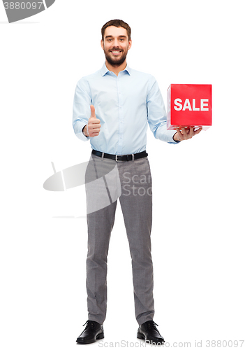 Image of smiling man with red shopping bag