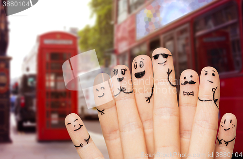 Image of close up of hands and fingers with smiley faces