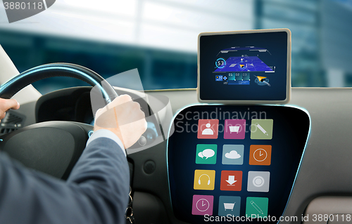 Image of close up of man with gps on tablet pc driving car