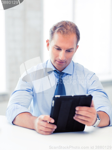 Image of businessman with tablet pc in office