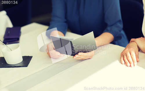 Image of close up of woman hands holding restaurant bill