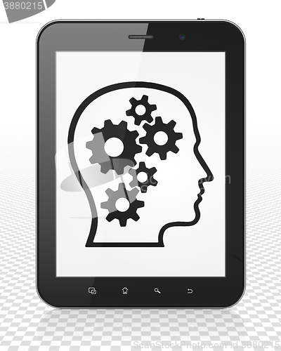 Image of Business concept: Tablet Pc Computer with Head With Gears on display