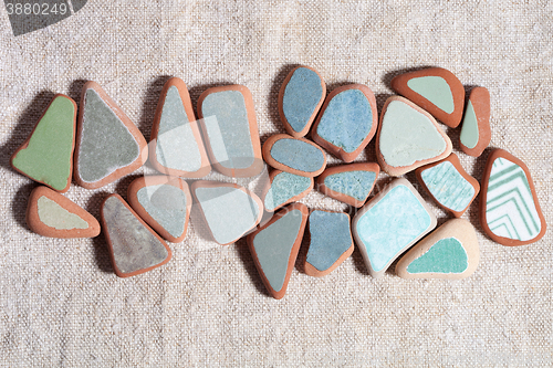 Image of pieces of colorful tiles polished by the sea