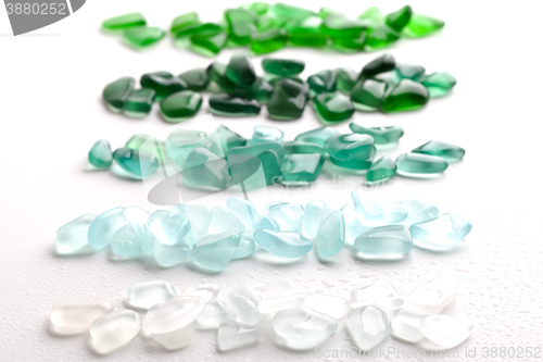 Image of wet glass pieces polished by the sea 