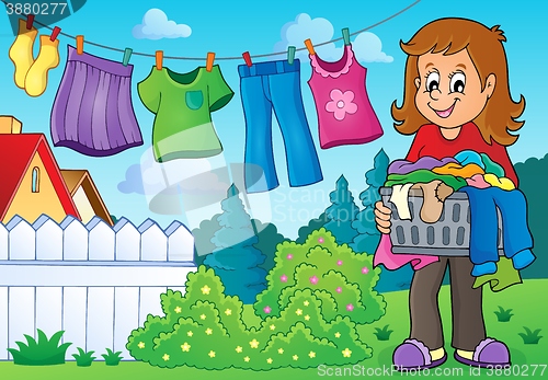 Image of Woman with laundry outdoor