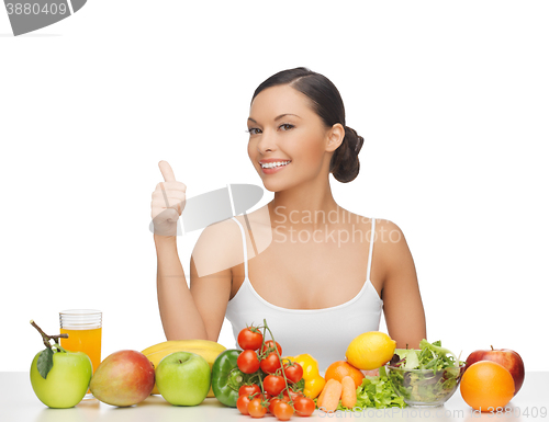 Image of woman gives thumbs up with fruits and vegetables