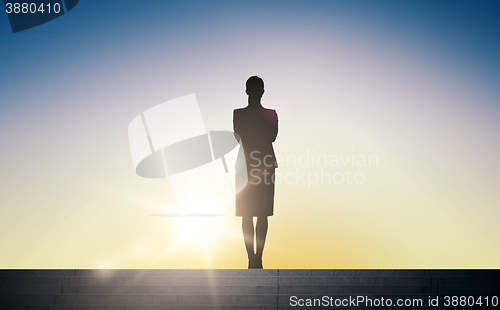 Image of silhouette of business woman with over sun light