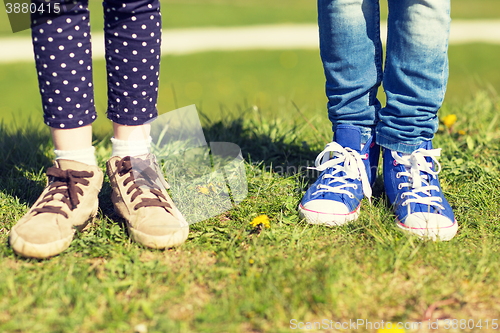 Image of close up of kids legs in shoes on grass outdoors