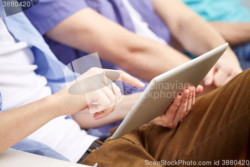 Image of close up of friends with tablet pc at home