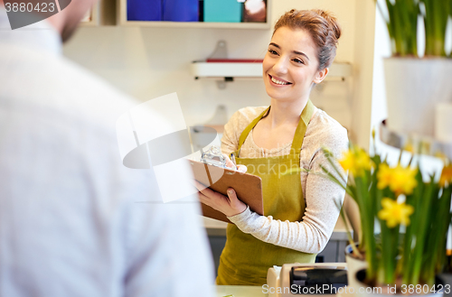 Image of florist woman and man making order at flower shop