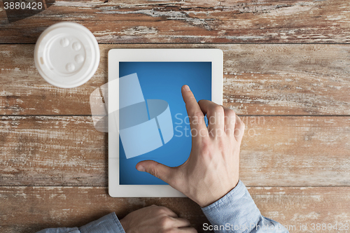 Image of close up of male hands with tablet pc and coffee