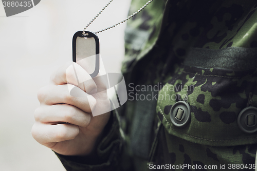 Image of close up of young soldier in military uniform