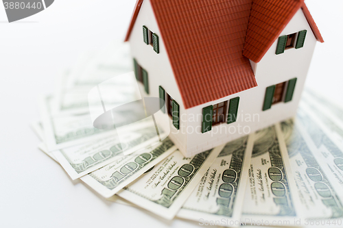 Image of close up of home or house model and money