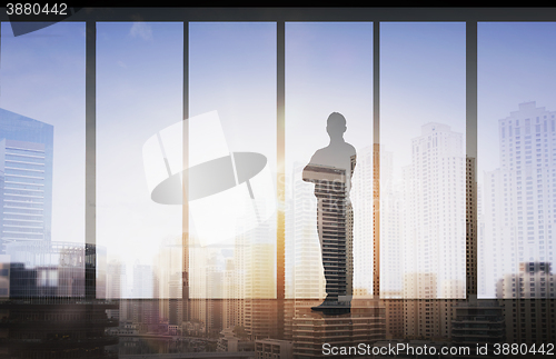 Image of silhouette of business man over office background