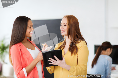 Image of creative team with table pc in office