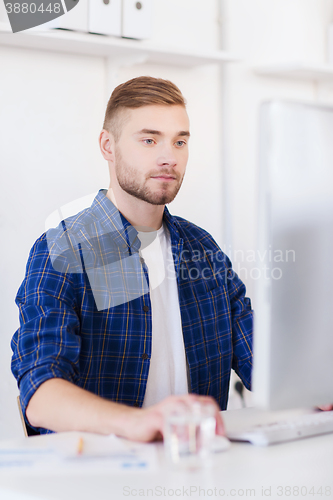 Image of creative man or student with computer at office